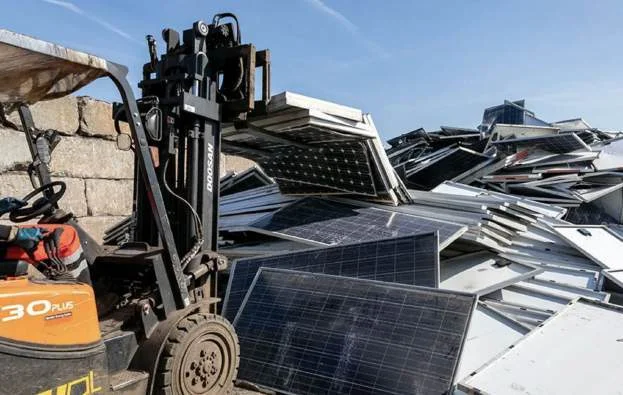 Decommissioned solar panels stored in a massive European warehouse